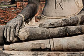 Ayutthaya, Thailand. Wat Mahathat, Buddha statue of the gallery enclosing the collapsed central prang. 